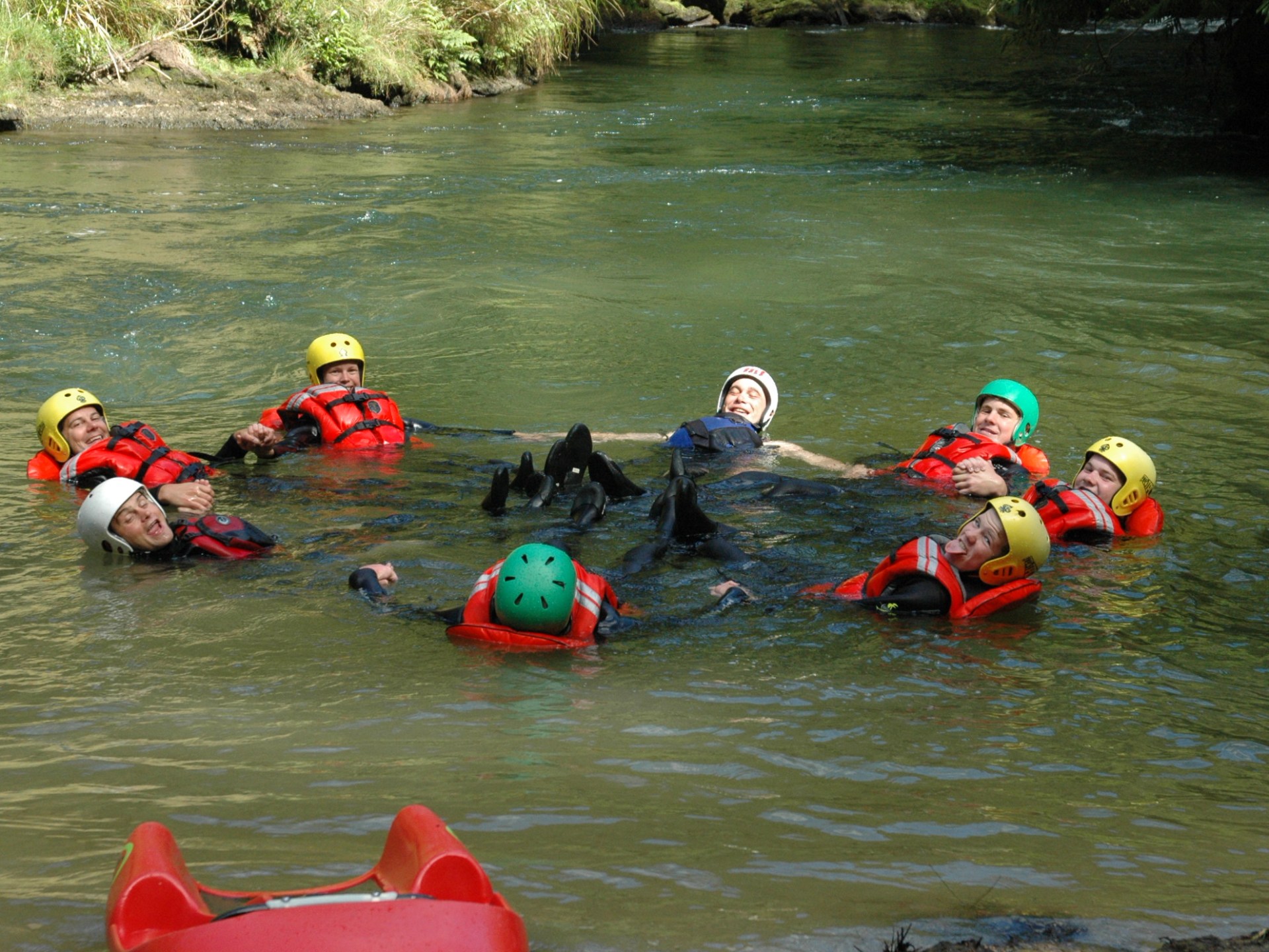 a group of people riding on a raft in the water