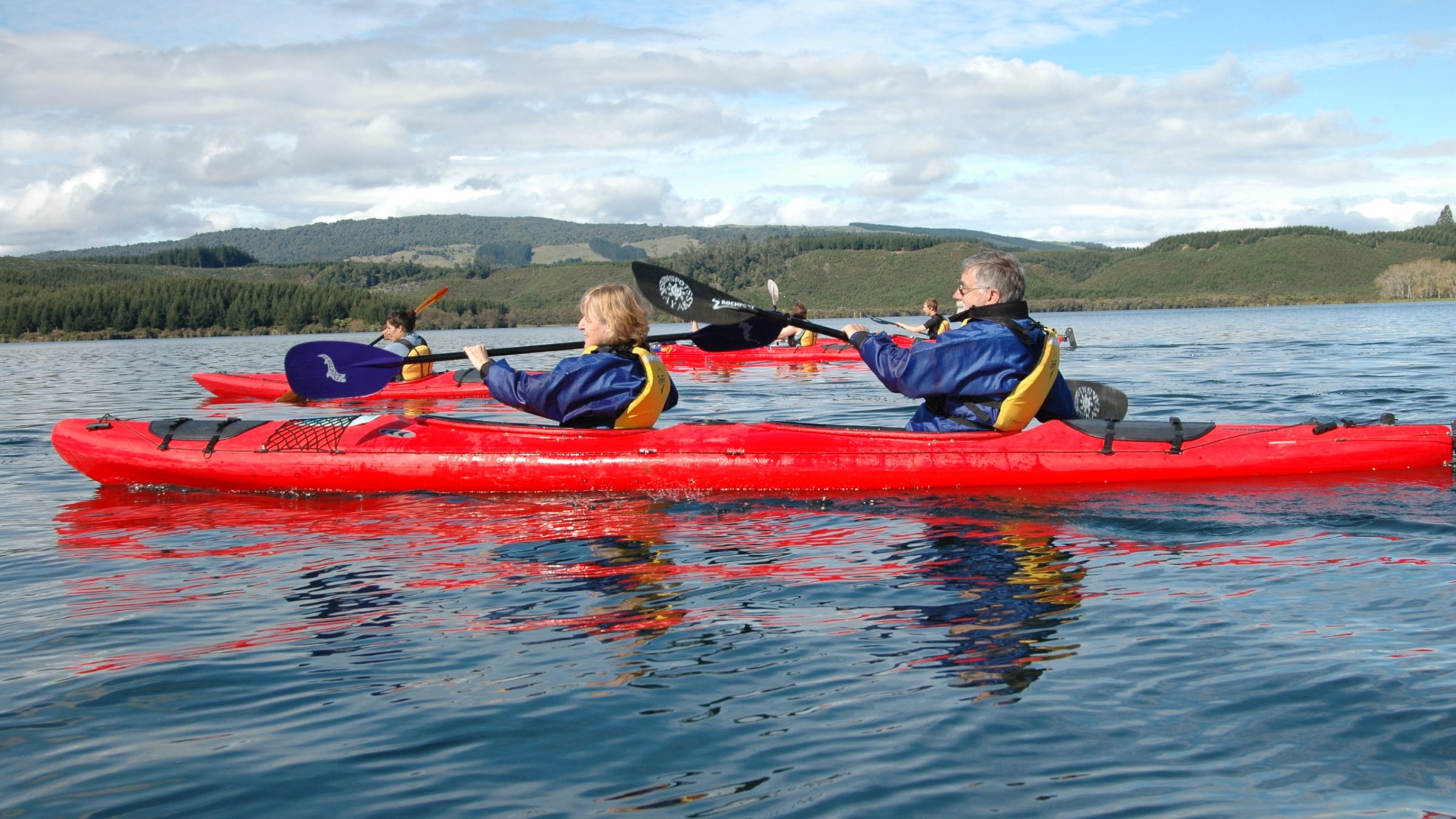 a group of people in a small boat in a body of water