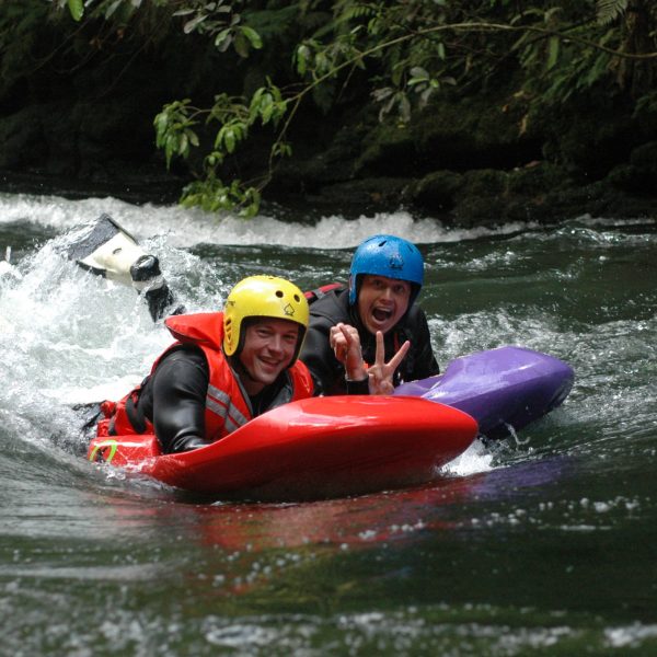 a man riding on a raft in a body of water