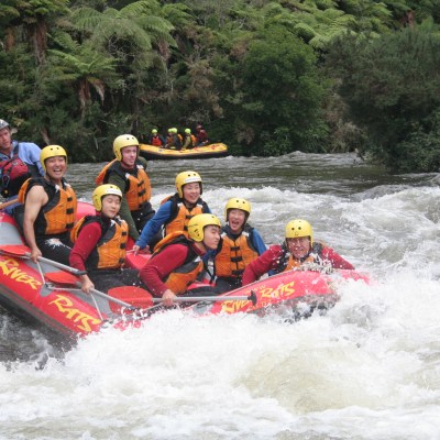 a group of people riding on a raft in a body of water
