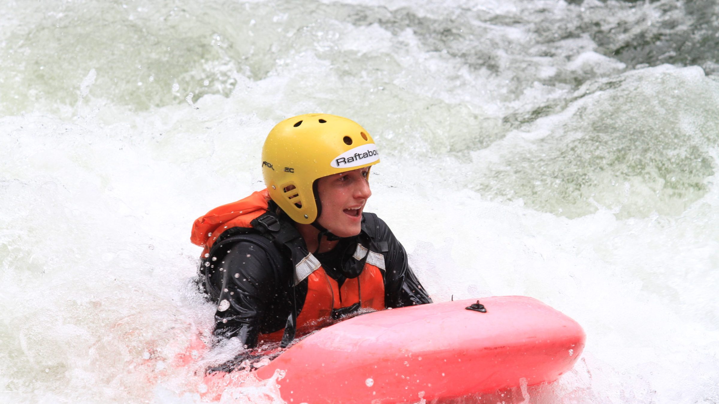a man riding a snow board on a body of water