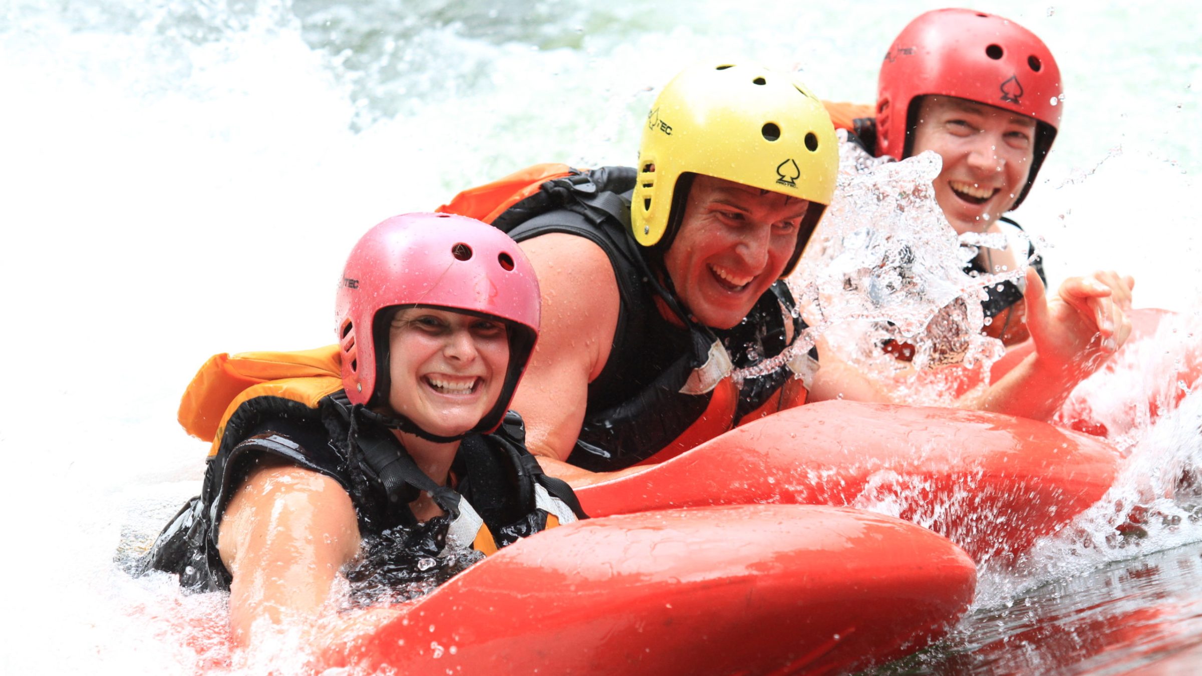 a person with a helmet on a raft in the water