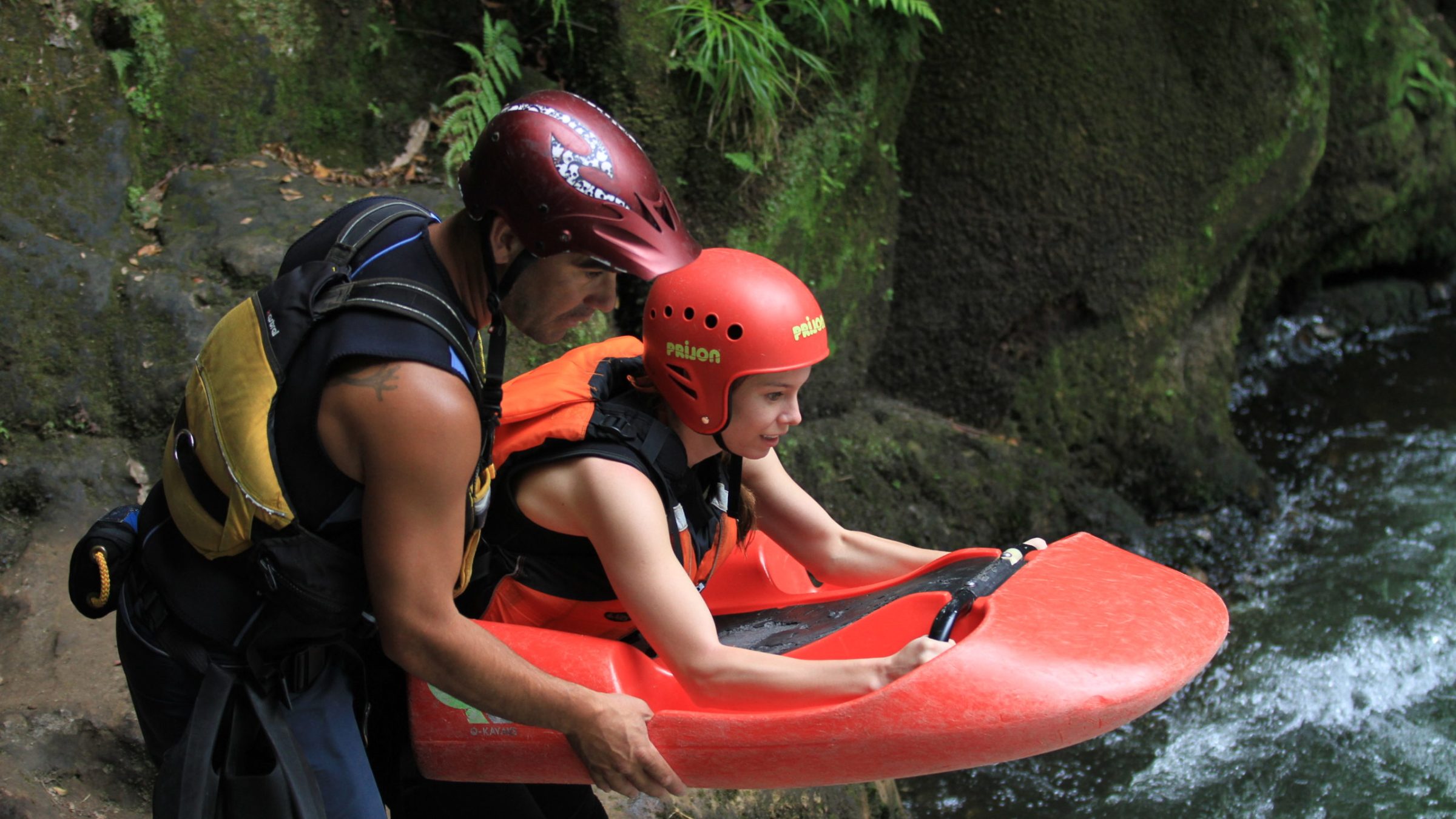 a young boy holding a baseball bat on a raft