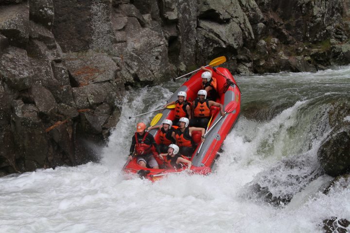 a man riding on a raft in the water