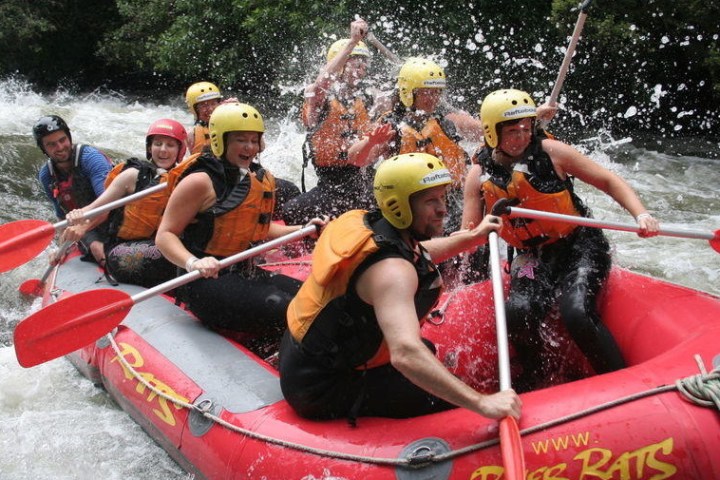 a group of people on a raft in the water